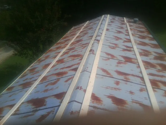 Rusted metal roof panels with new wood purlins before replacement — Storm Damage Roof Repair in Orrs Island by Roofing Brothers